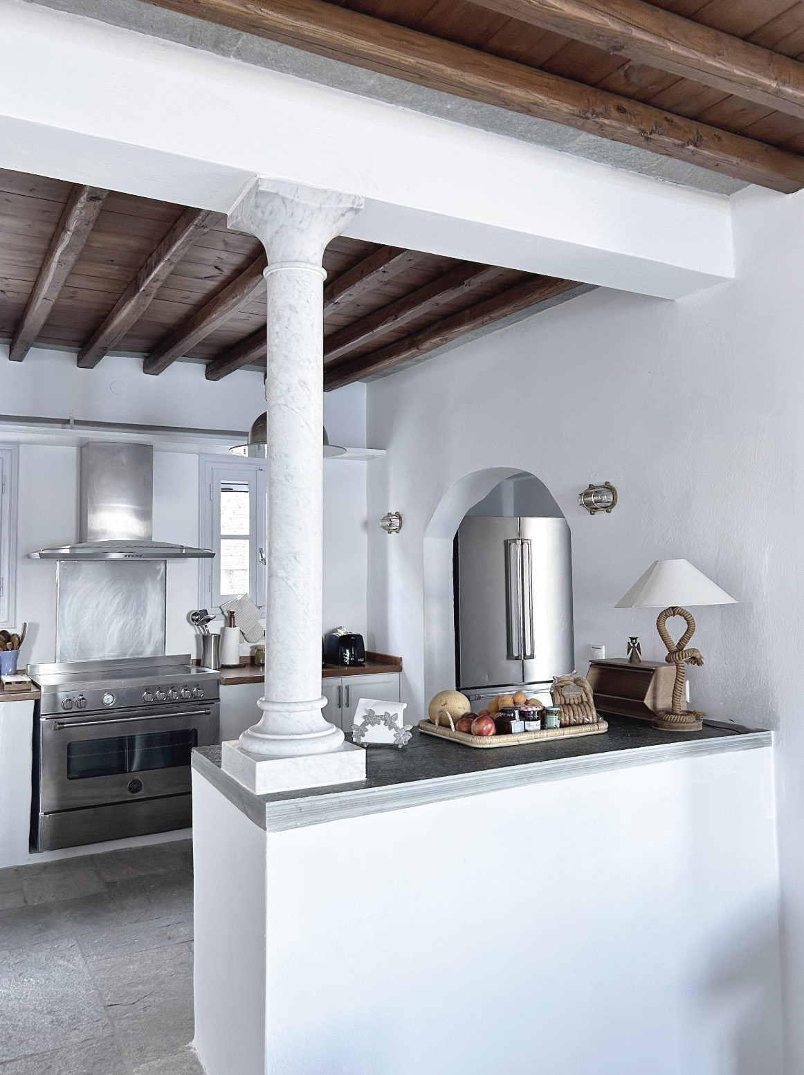 Kitchen with island and marble column